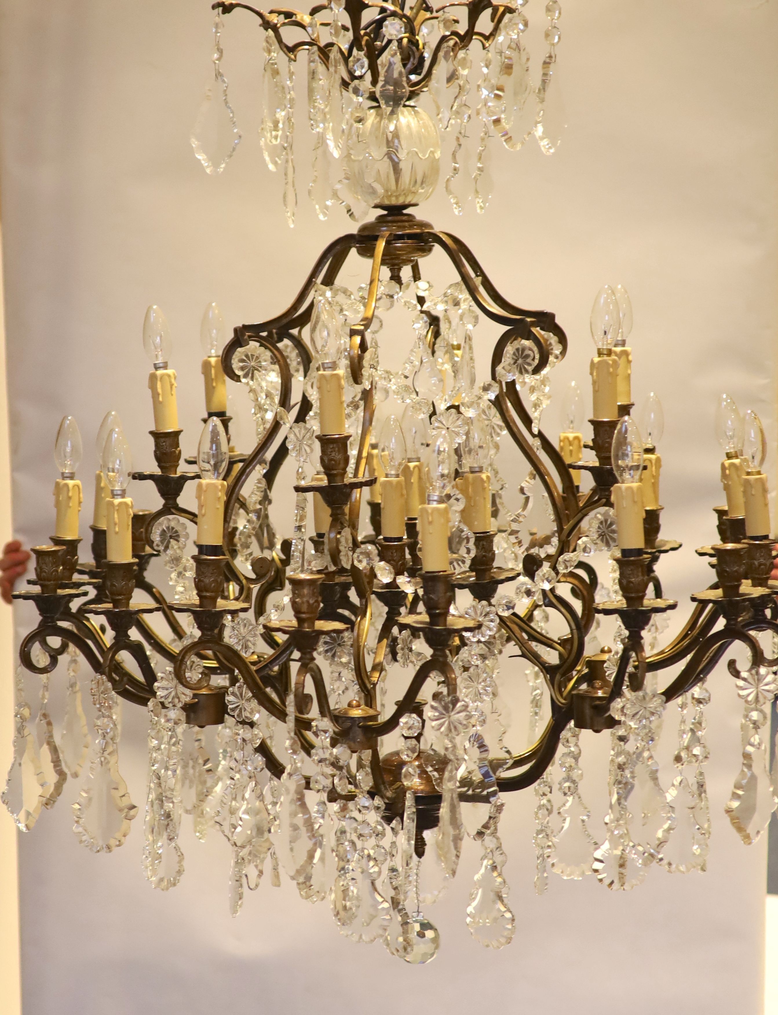 An 18th century style bronzed metal, cut glass 30 light chandelier by Christopher Wray, approximately 123 cm high